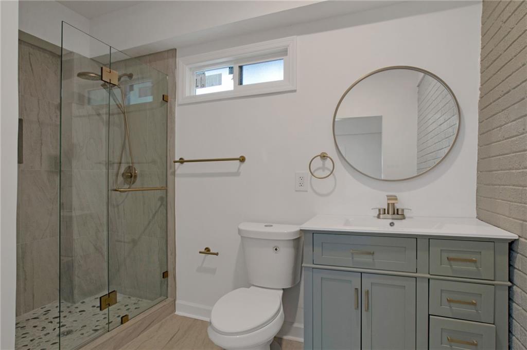 2326 Mark Trail Decatur, GA 30032 - Photo 16 of 19 a bathroom with a sink toilet and shower