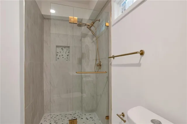 a bathroom with a shower and toilet