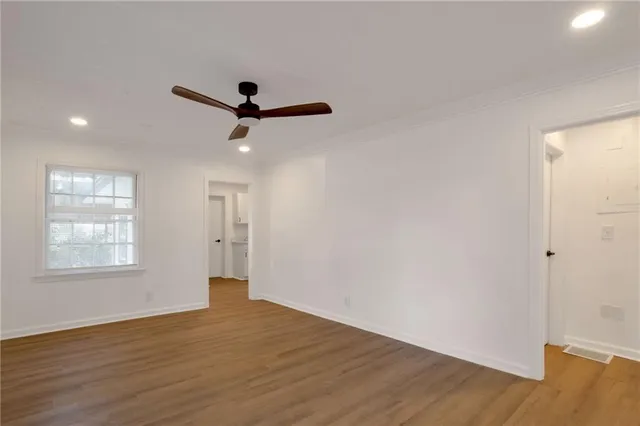 wooden floor in an empty room with a window