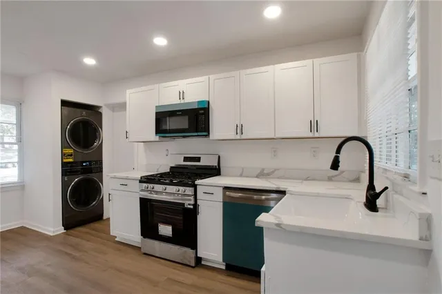 a kitchen with a sink a stove and cabinets
