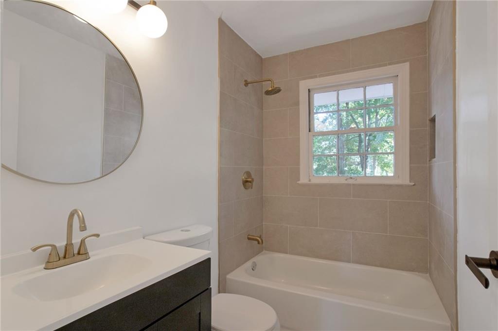 2326 Mark Trail Decatur, GA 30032 - Photo 10 of 19 a bathroom with a sink tub vanity and a mirror