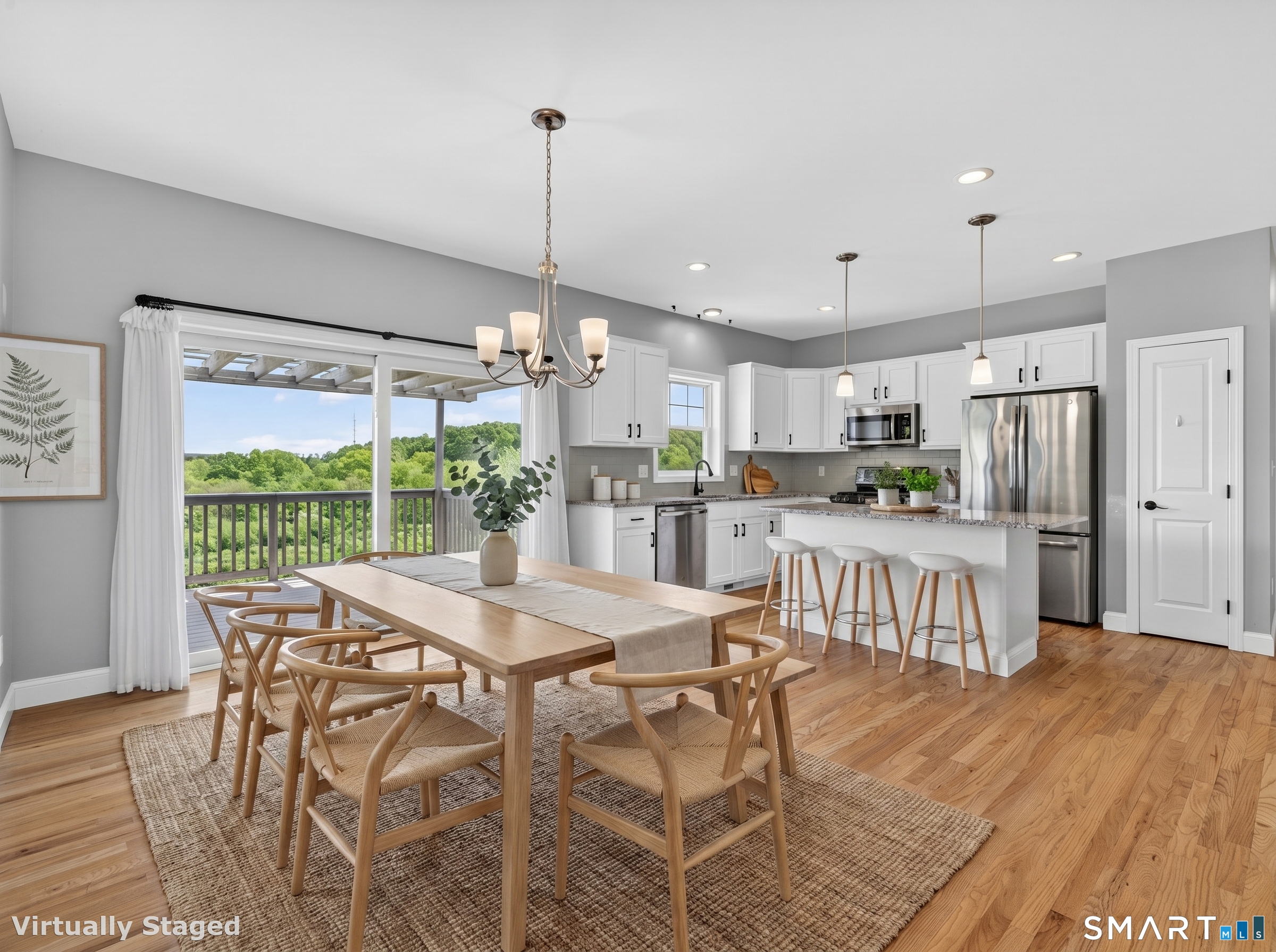 650 Ridgewood Road Middletown, CT 06457 - Photo 11 of 40 a kitchen with stainless steel appliances kitchen island granite countertop a refrigerator a stove a microwave oven a dining table and chairs with wooden floor