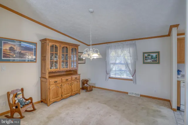 a view of a livingroom with furniture and natural light