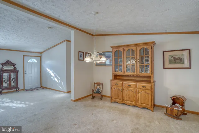 a kitchen with granite countertop stainless steel appliances a refrigerator a sink and cabinets