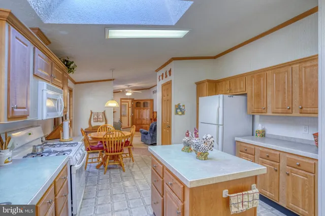 a living room with furniture a large window and a chandelier