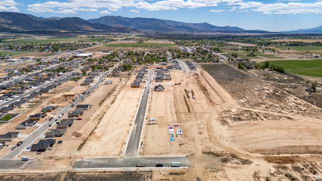 4978 North 75 East Enoch, UT 84721 - Photo 58 of 60 Expansive aerial captures a developing residential community featuring numerous completed homes, new road infrastructure, and available building lots