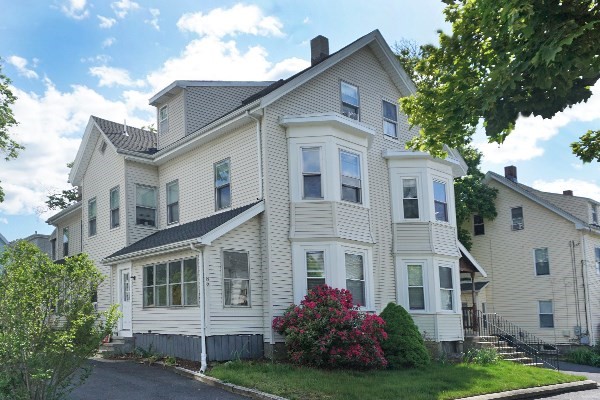 85 Brown Street, Unit 2 Waltham, MA 02453 - Photo 1 of 8 a front view of a house with a yard and trees