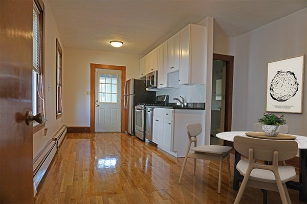 85 Brown Street, Unit 2 Waltham, MA 02453 - Photo 2 of 8 a kitchen with a sink cabinets and wooden floor