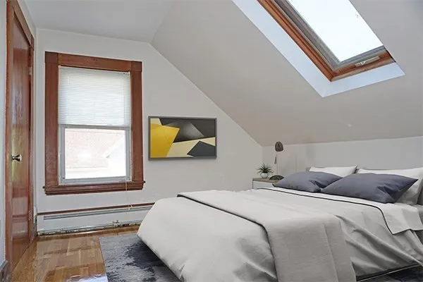 a bedroom with a bed and a window