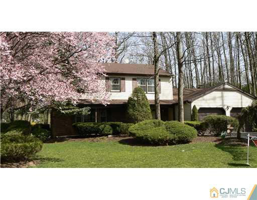 11 Pine Ridge Drive Edison, NJ 08820 - Photo 1 of 25 a black and white house with a yard and a large tree