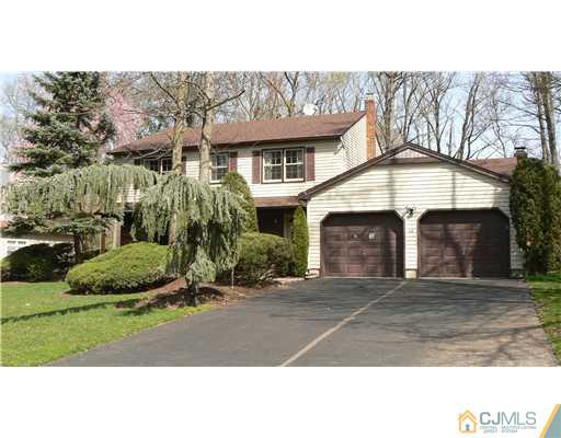 11 Pine Ridge Drive Edison, NJ 08820 - Photo 2 of 25 a front view of a house with a yard and garage