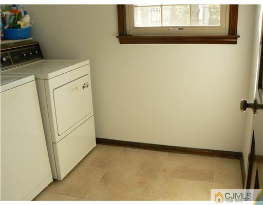 11 Pine Ridge Drive Edison, NJ 08820 - Photo 15 of 25 a view of a storage & utility room with a refrigerator