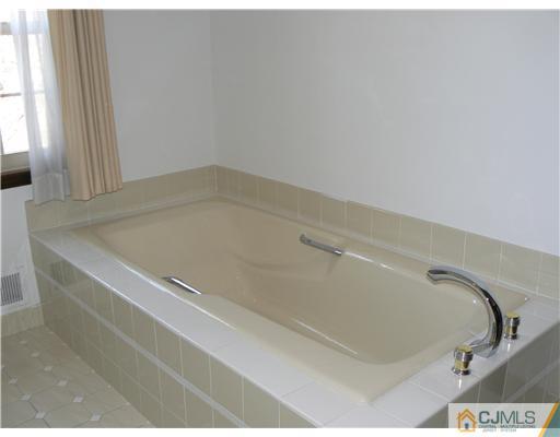 11 Pine Ridge Drive Edison, NJ 08820 - Photo 18 of 25 a bath tub sitting in a bathroom