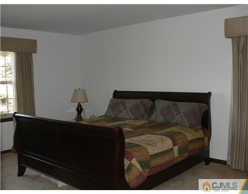 11 Pine Ridge Drive Edison, NJ 08820 - Photo 20 of 25 a bedroom with a bed and window