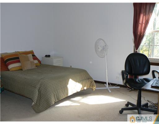 11 Pine Ridge Drive Edison, NJ 08820 - Photo 23 of 25 a bedroom with a bed a desk and chair