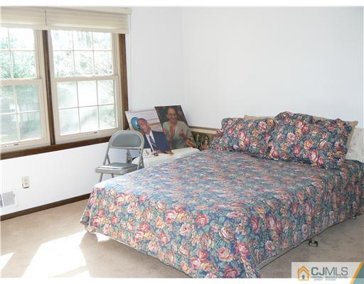 11 Pine Ridge Drive Edison, NJ 08820 - Photo 24 of 25 a large bed sitting in a bedroom next to a window