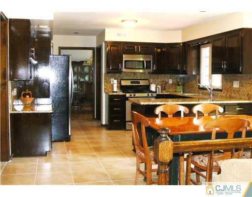 11 Pine Ridge Drive Edison, NJ 08820 - Photo 6 of 25 a kitchen with stainless steel appliances granite countertop a refrigerator and a stove