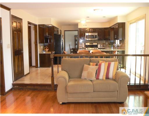 11 Pine Ridge Drive Edison, NJ 08820 - Photo 7 of 25 a living room with furniture a large window and chandelier