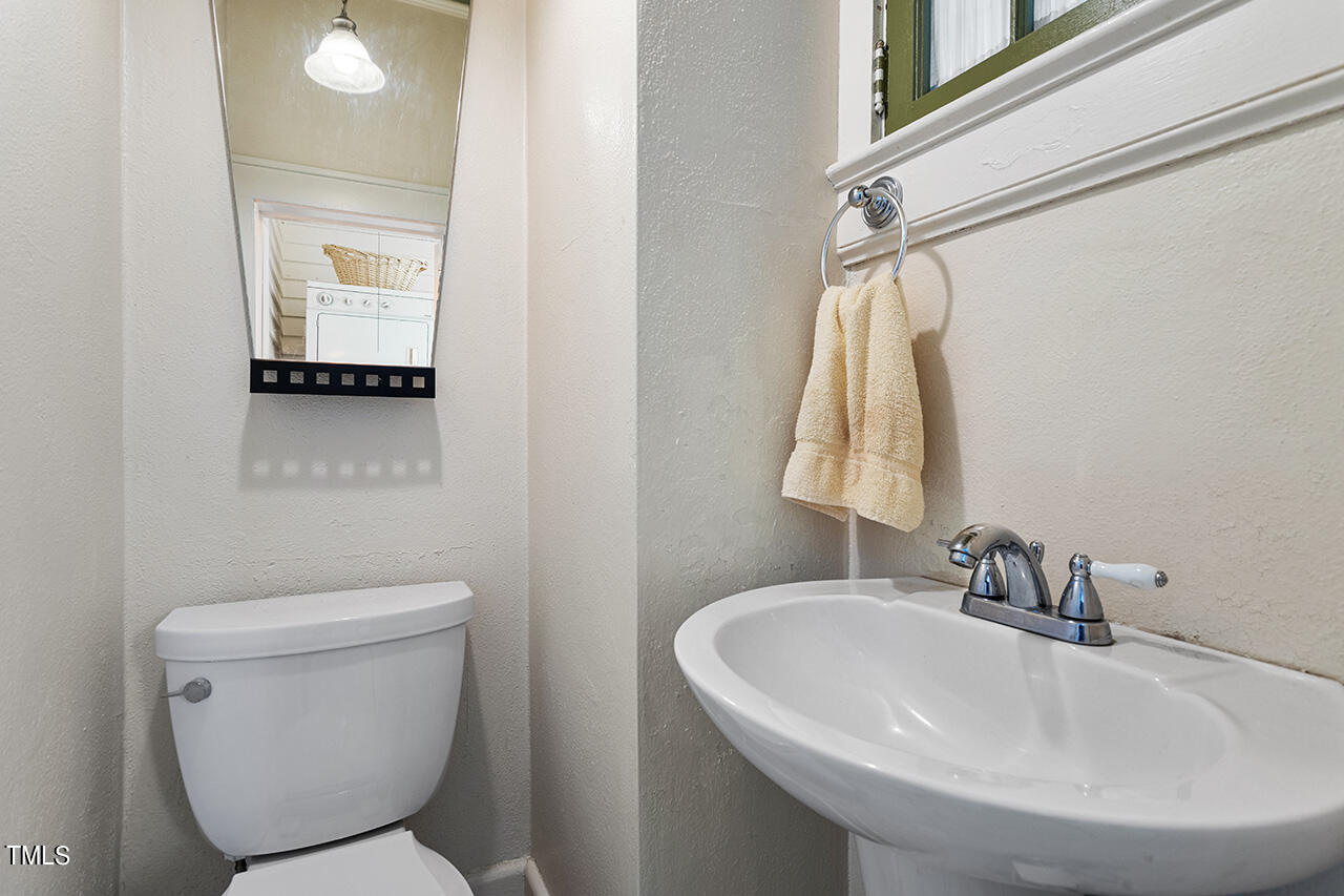 904 North Gregson Street Durham, NC 27701 - Photo 11 of 34 a bathroom with a sink a toilet and a mirror