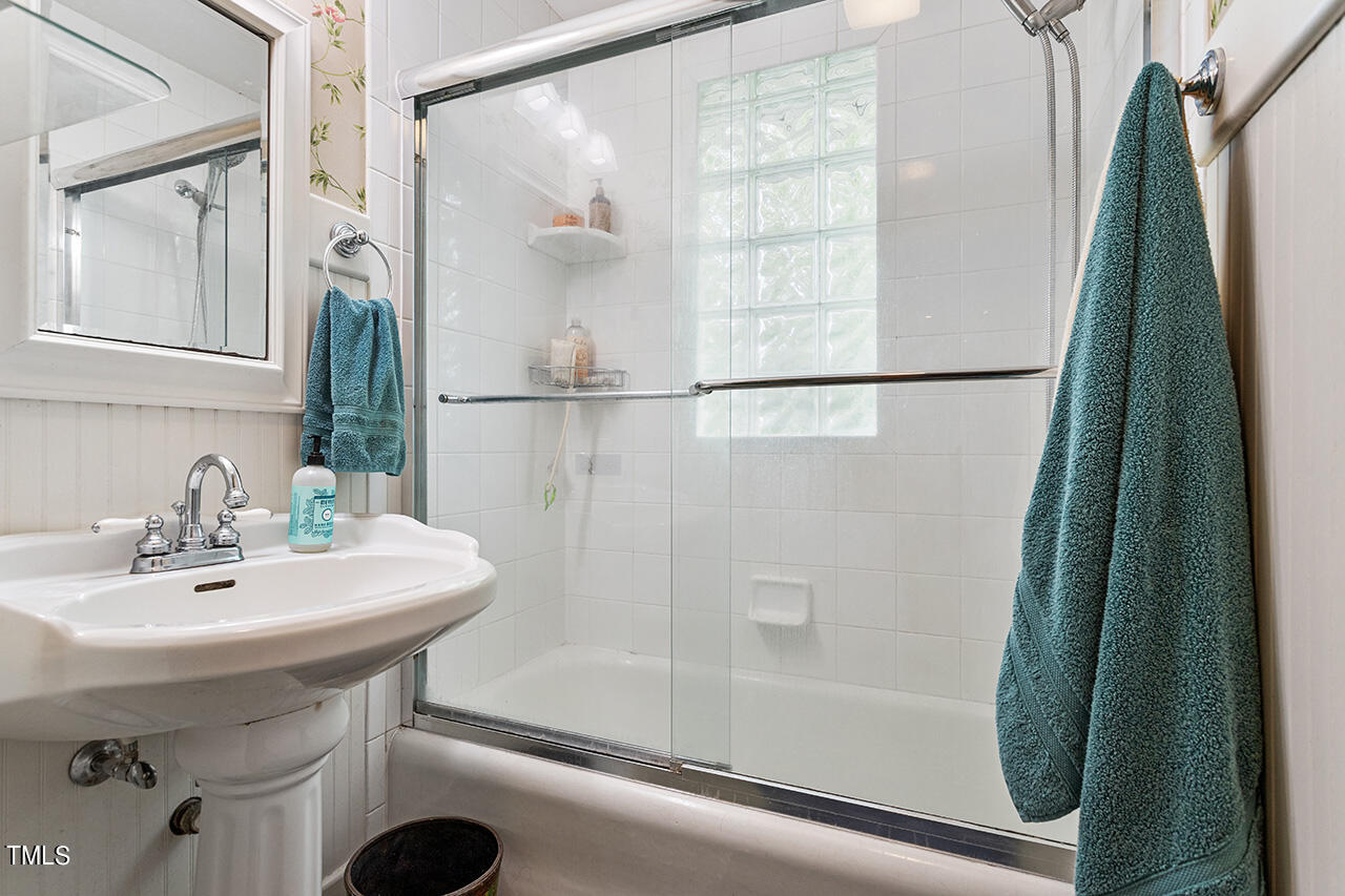904 North Gregson Street Durham, NC 27701 - Photo 13 of 34 a bathroom with a sink a mirror and a bathtub