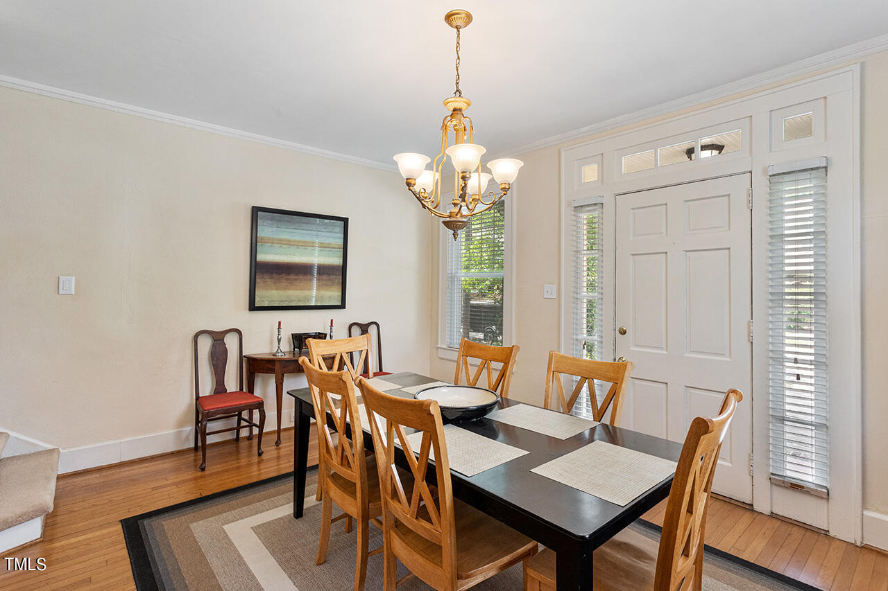 904 North Gregson Street Durham, NC 27701 - Photo 19 of 34 a dining room with furniture a chandelier and wooden floor