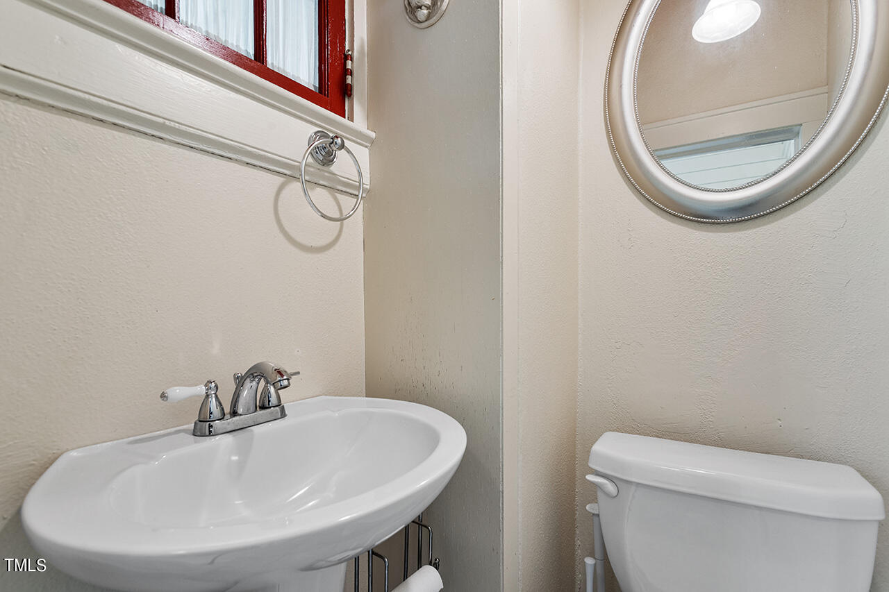 904 North Gregson Street Durham, NC 27701 - Photo 26 of 34 a bathroom with a sink a toilet and a mirror