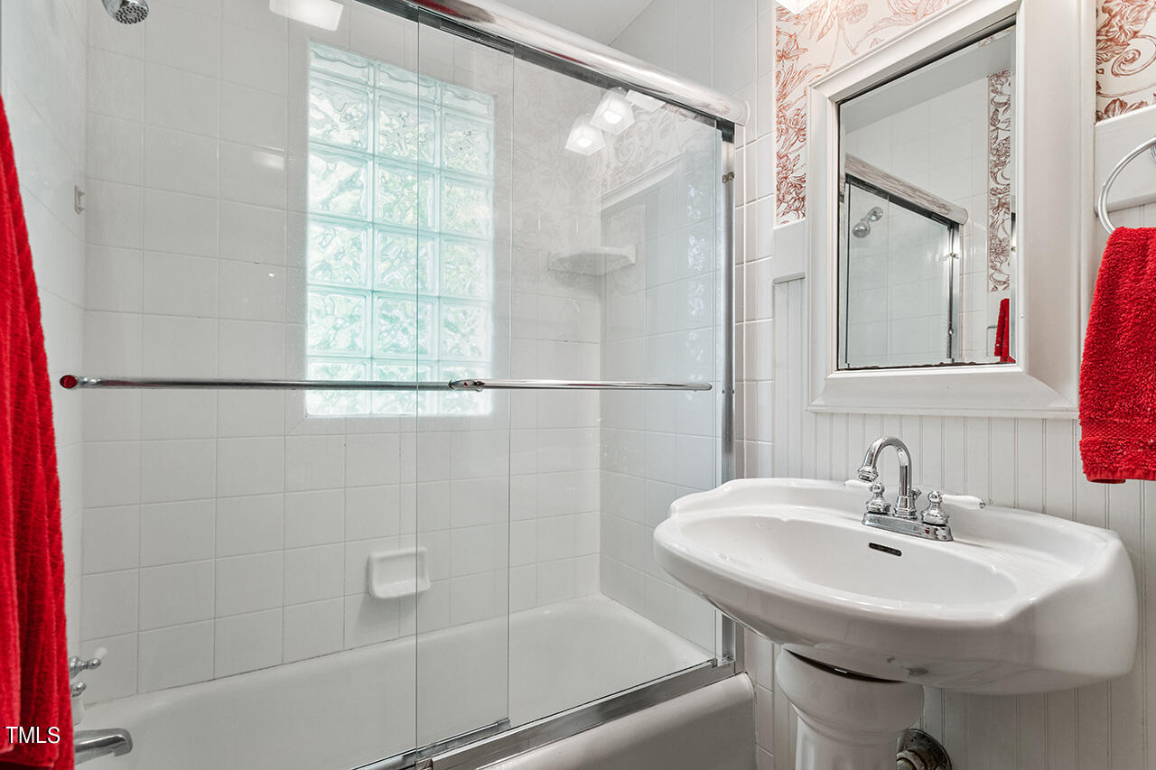 904 North Gregson Street Durham, NC 27701 - Photo 29 of 34 a bathroom with a sink shower and a mirror