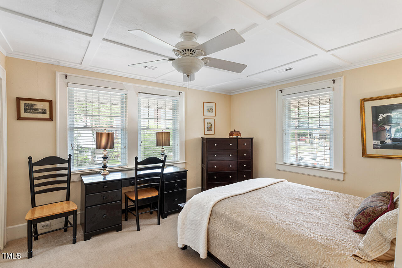 904 North Gregson Street Durham, NC 27701 - Photo 32 of 34 a bedroom with a bed and a chandelier
