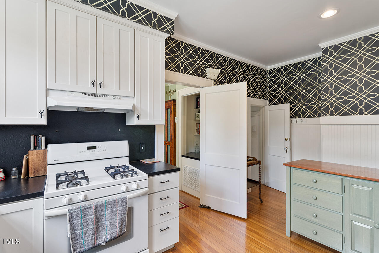904 North Gregson Street Durham, NC 27701 - Photo 7 of 34 a kitchen with a stove and white cabinets