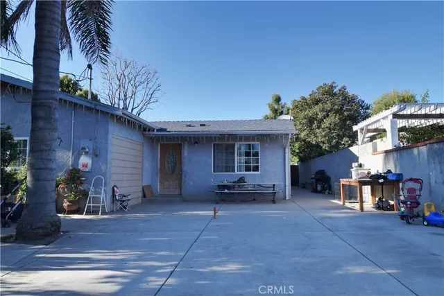 a view of a house with a patio and a yard