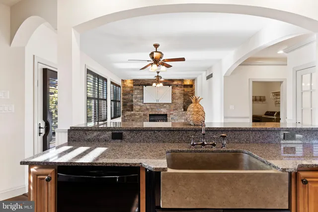 a kitchen with granite countertop a stove and a sink