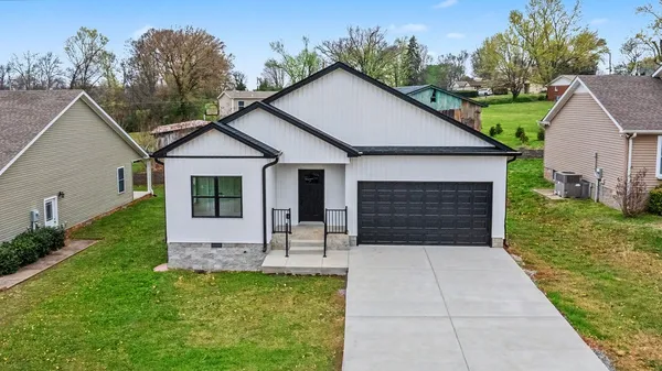 a front view of house with yard and green space