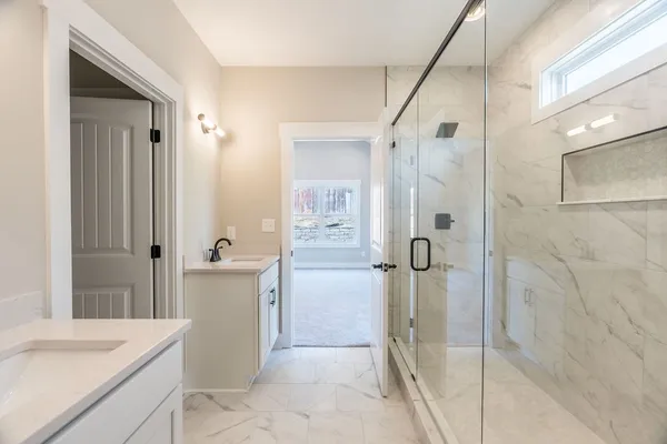 a bathroom with a granite countertop shower mirror and a sink