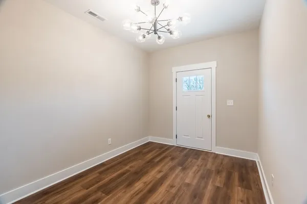 a view of room with window and hardwood floor