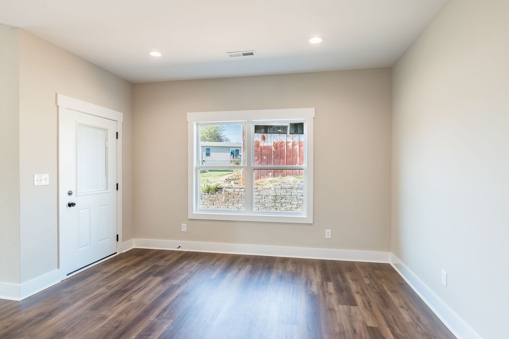 104 Bee Line Way Trenton, KY 42286 - Photo 5 of 23 an empty room with wooden floor and windows