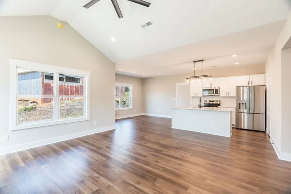 a view of kitchen with wooden floor and electronic appliances