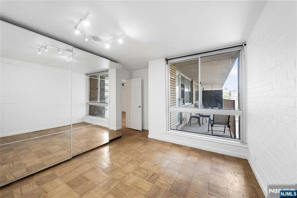 a view of an empty room with a fireplace and a window
