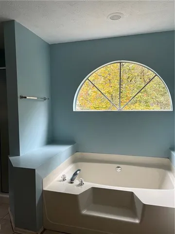 a bathroom with a glass shower door