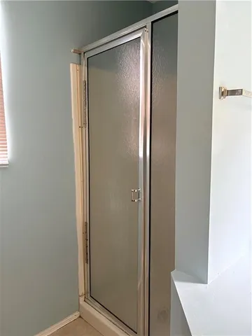 a view of an empty room with closet and a window