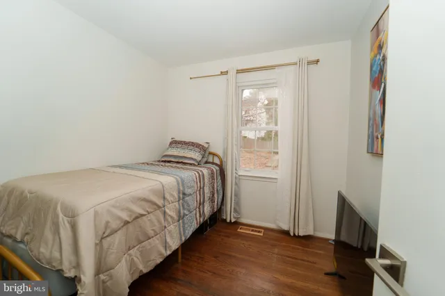 a bed sitting in a bedroom next to a window