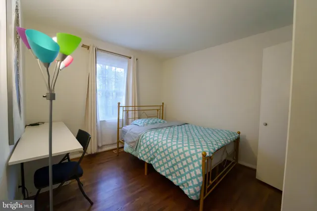 a bedroom with a bed and a table in it