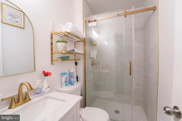 a bathroom with a sink toilet and shower