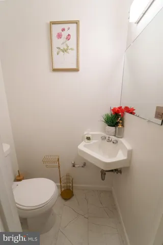 a bathroom with a sink toilet and a mirror