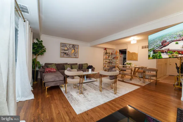 a living room with furniture and wooden floor