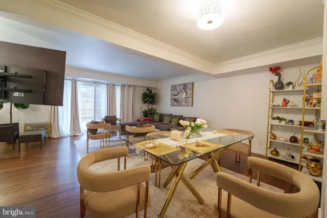 a dining room with furniture and wooden floor