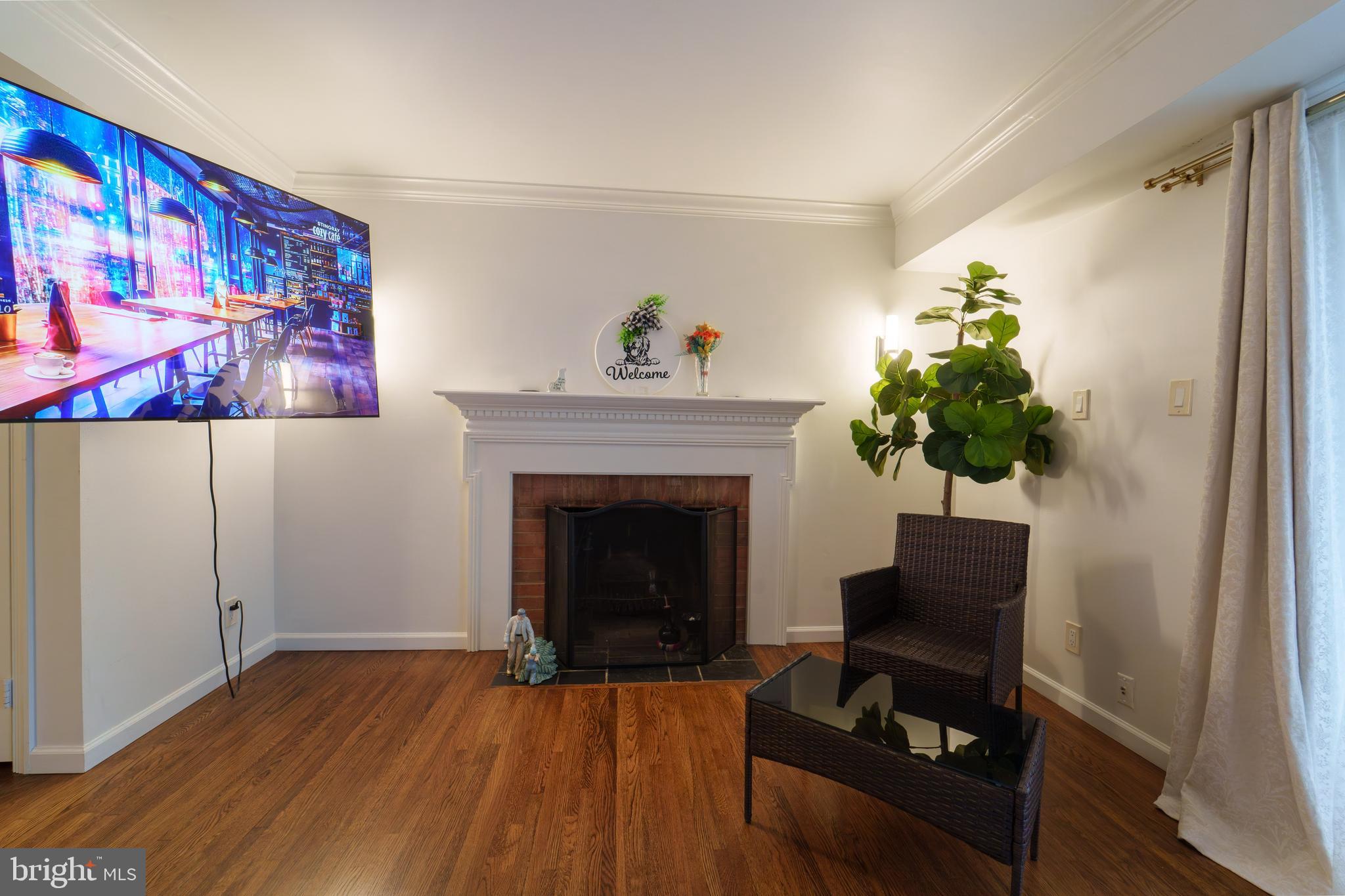 7625 Tiverton Drive, Unit 7625 Springfield, VA 22152 - Photo 5 of 22 a living room with furniture and a fireplace