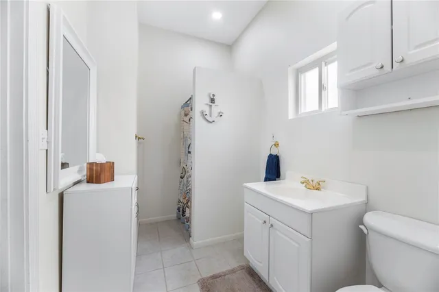 a living room with furniture and a kitchen view