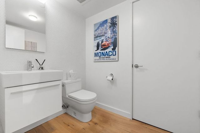 a bathroom with a sink toilet and vanity
