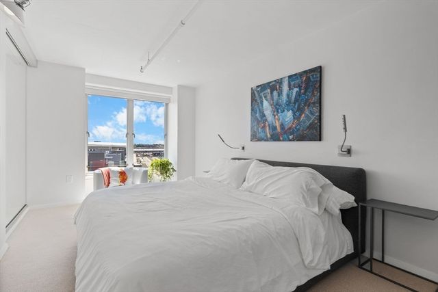 a bedroom with a large bed and a window