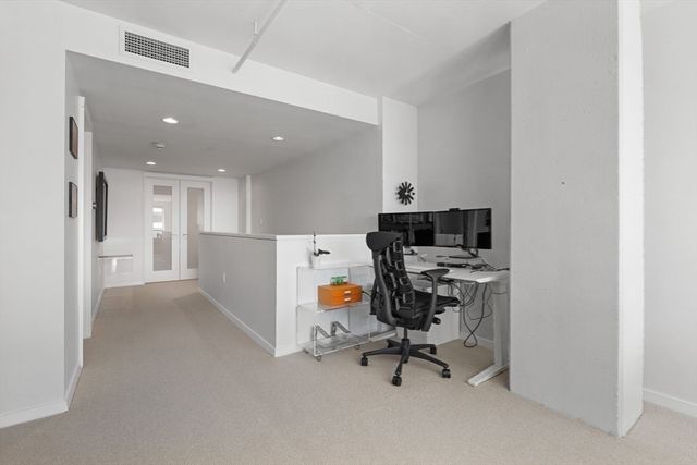 a living room with furniture and a book shelf